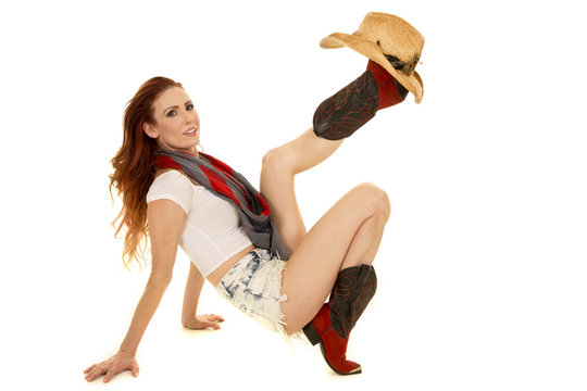 cowgirl with red hair hat on boot