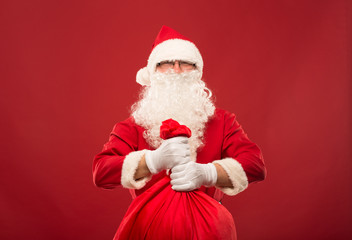 Portrait of happy Santa Claus with a huge sack