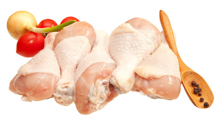 Raw chicken legs with vegetables, isolated on white background