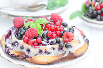 delicious pie with summer berries and mint on white background
