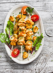 chicken kebab with pumpkin and onions on a light wooden surface. Healthy food