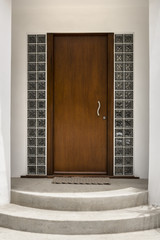 Front brown door, front view of front door with steps and windows
