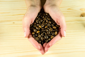 Coffee beans in beautiful hands