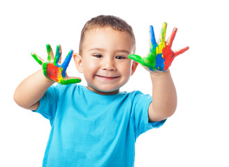 portrait of cute kid having fun with hands paint