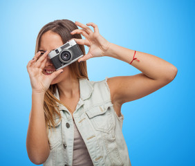 portrait of a pretty young woman taking photo with her camera