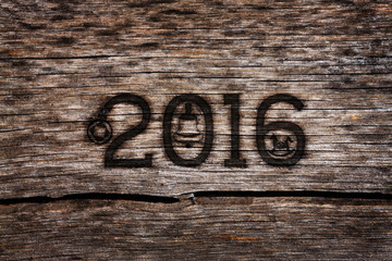 New year 2016 burning number in the old cracked wood with grunge look