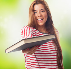 portrait of a beautiful young woman giving a book