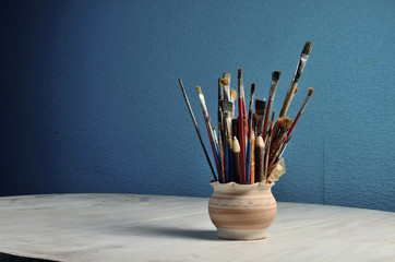 Brushes in a clay jug