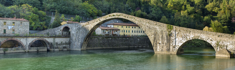 old bridge above the river in Italy