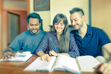 Group of multiracial students reading books home - Young business people doing teamwork - Multiethnic concept of social interaction and joy - Vintage filtered look with radial zoom defocus
