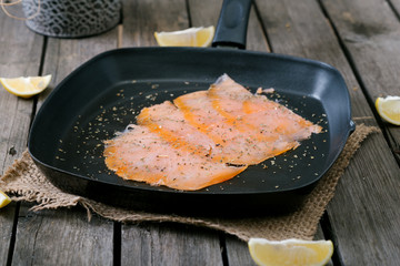 Salmon in frying pan.