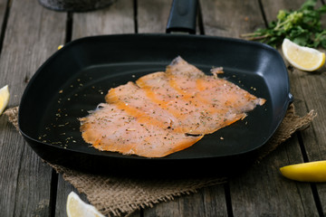 Salmon in frying pan.