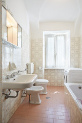 Fototapeta na wymiar Simple, pink bathroom in old apartment