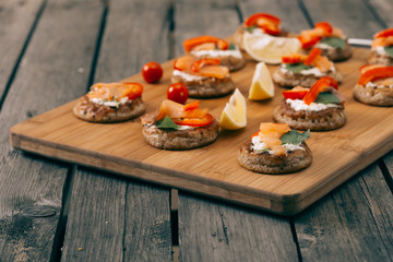 Blinis on the wooden table, Salmon sandwich .