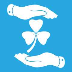 two hands with Clover with three leaves sign icon. on a blue bac