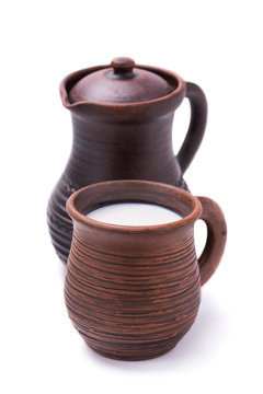 Mug of milk and a jug isolated on white background