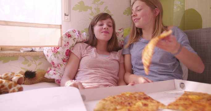 Girl Joking And Feeding Her Friend Huge Slice Of Pizza