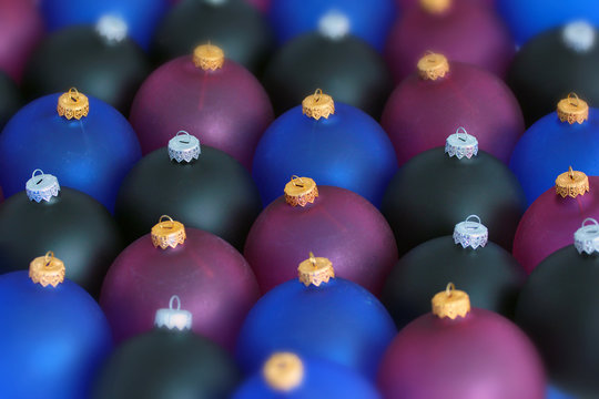 Blurred background of black, blue and red christmas balls