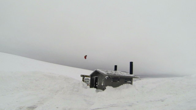 Snowkite over snow forest service cabin winter HD 0008