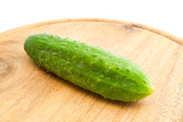 cucumber on wooden cutting board