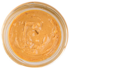 Peanut butter in a mason jar over white background