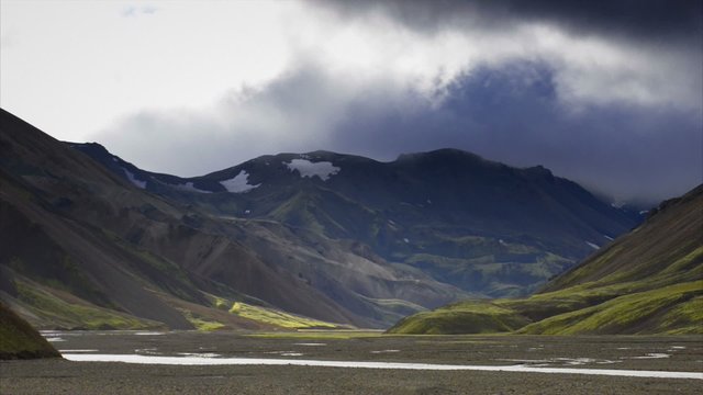 Clouds moving over the colorful mountains of the Landmannalaugar area in Iceland.