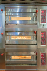 Bread rolls baking in oven in a commercial kitchen