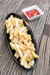 French fries with ketchup on wood table