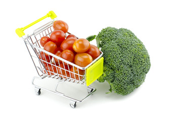 Fresh raw green broccoli, cherry tomatoes on trolley isolated on white background
