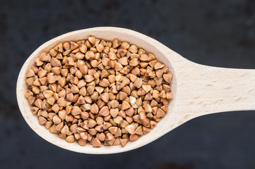 Buckwheat in a wooden spoon