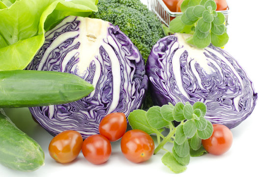 closeup view healthy vegetable. purple cabbage, cherry tomatoes, mint, salad and zucchini isolated white background
