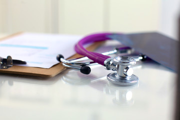 Medical stethoscope and a plate on the table