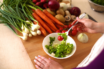 Young Woman Cooking in the kitchen. Healthy Food
