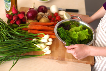 Young Woman Cooking in the kitchen. Healthy Food