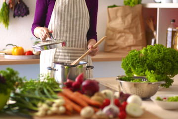 Young Woman Cooking in the kitchen. Healthy Food