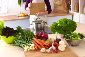 Young Woman Cooking in the kitchen. Healthy Food