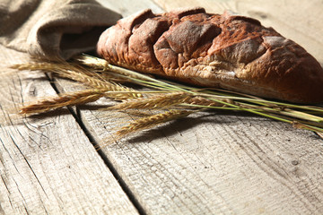 Freshly baked traditional bread on wooden table