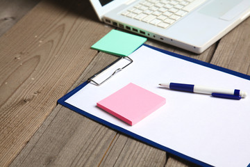 blank notebook on wooden table with pencils