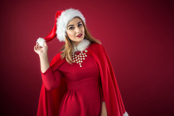 Portrait of beautiful sexy girl wearing Santa Claus clothes on r