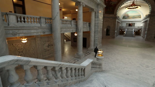 Utah State Capital pan across stairs man walks away HD 4755
