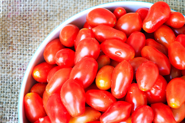 Group of cherry tomatoes put on sack