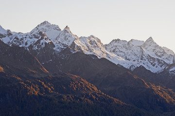 Fototapeta na wymiar Snow covered mountain peaks in the evening light