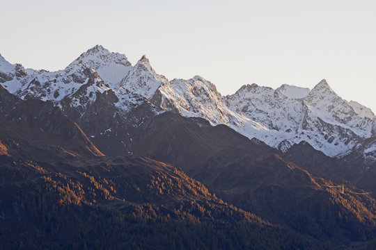 Snow covered mountain peaks in the evening light