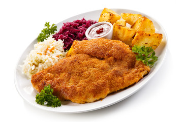 Fried pork chop, baked potatoes and vegetable salad 