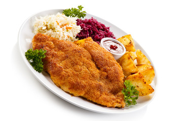 Fried pork chop, baked potatoes and vegetable salad 