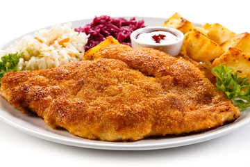 Fried pork chop, baked potatoes and vegetable salad 