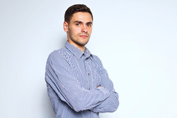 Portrait of young business man posing on gray background