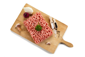 Raw minced pork on cutting board and vegetables 