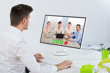 Businessman Videoconferencing With Colleagues