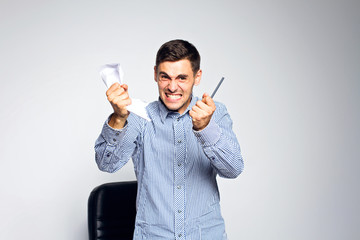 Emotional business man with paper on gray background